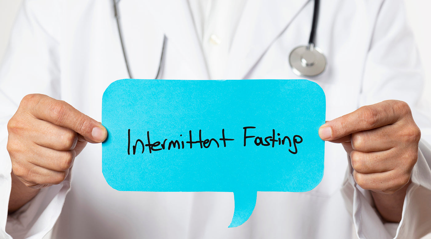  doctor holding intermittent fasting sign