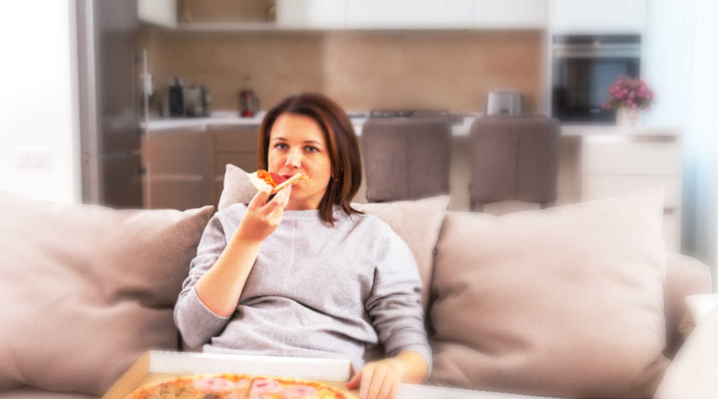  woman eating pizza in front of TV