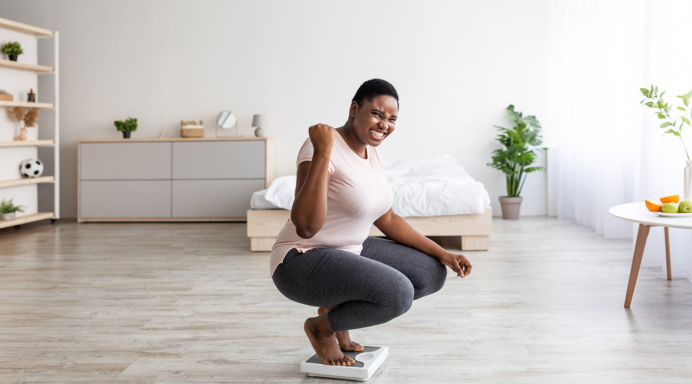  happy overweight woman on scale