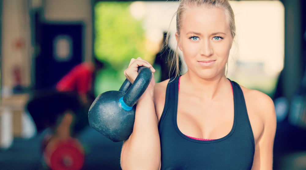 women in gym with kettlebell