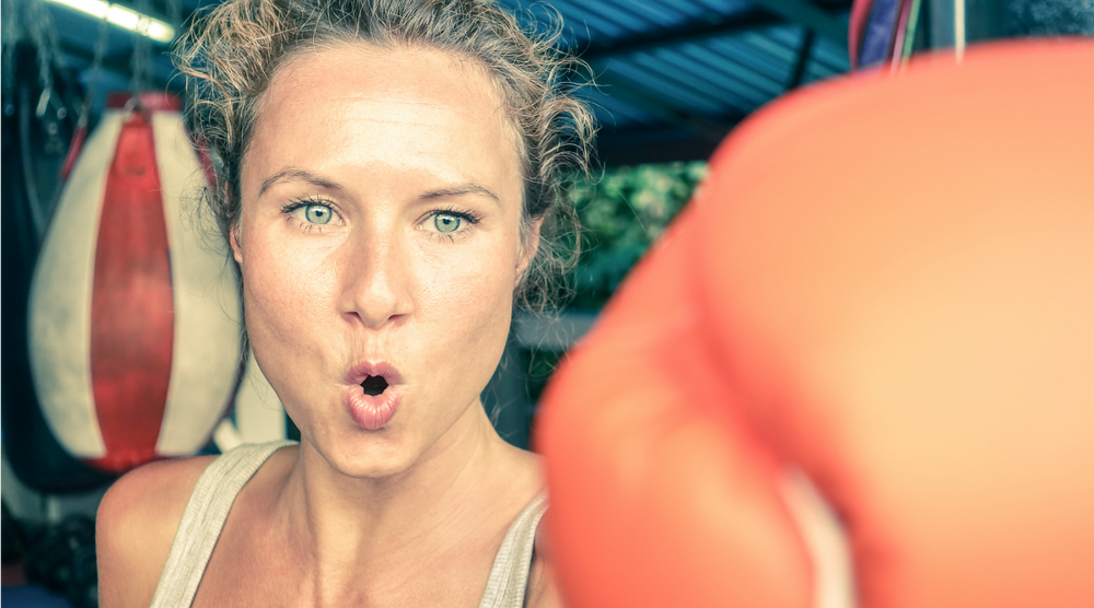 Woman hitting punching bag