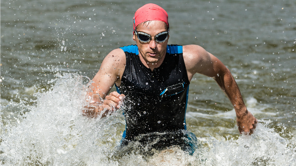 Male triathlete exiting the wated