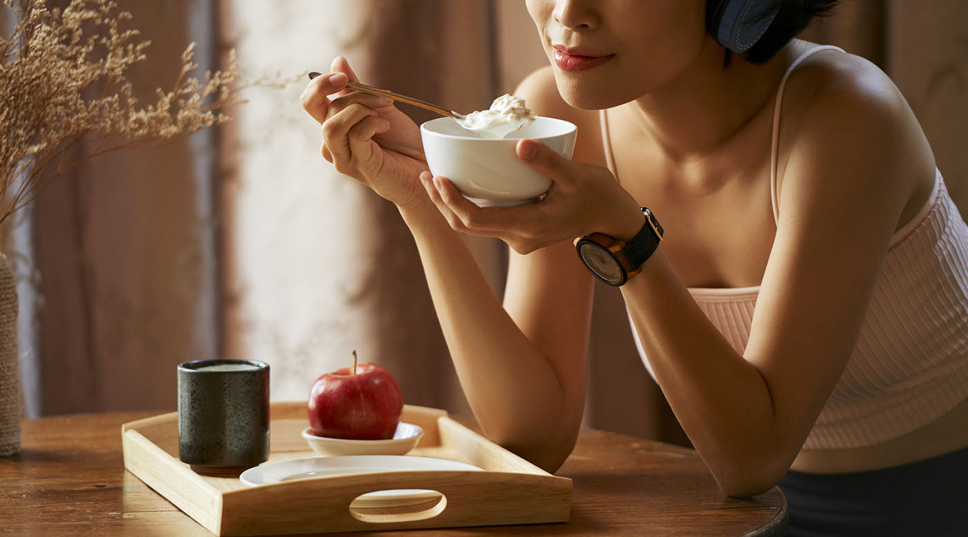  woman eating breakfast thoughtfully