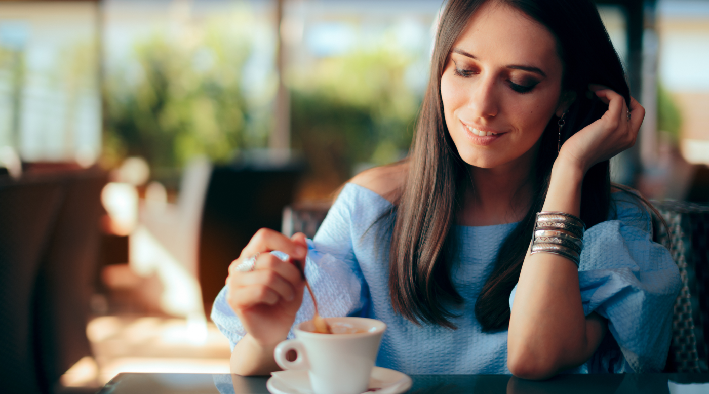  woman drinking coffee with Invigor8 collagen peptides